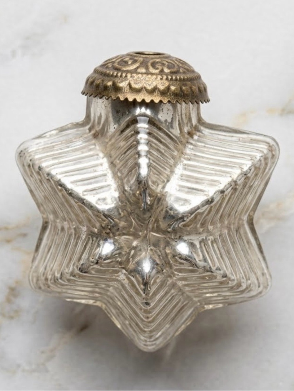 This is a vintage Kugel glass star Christmas ornament. Mini